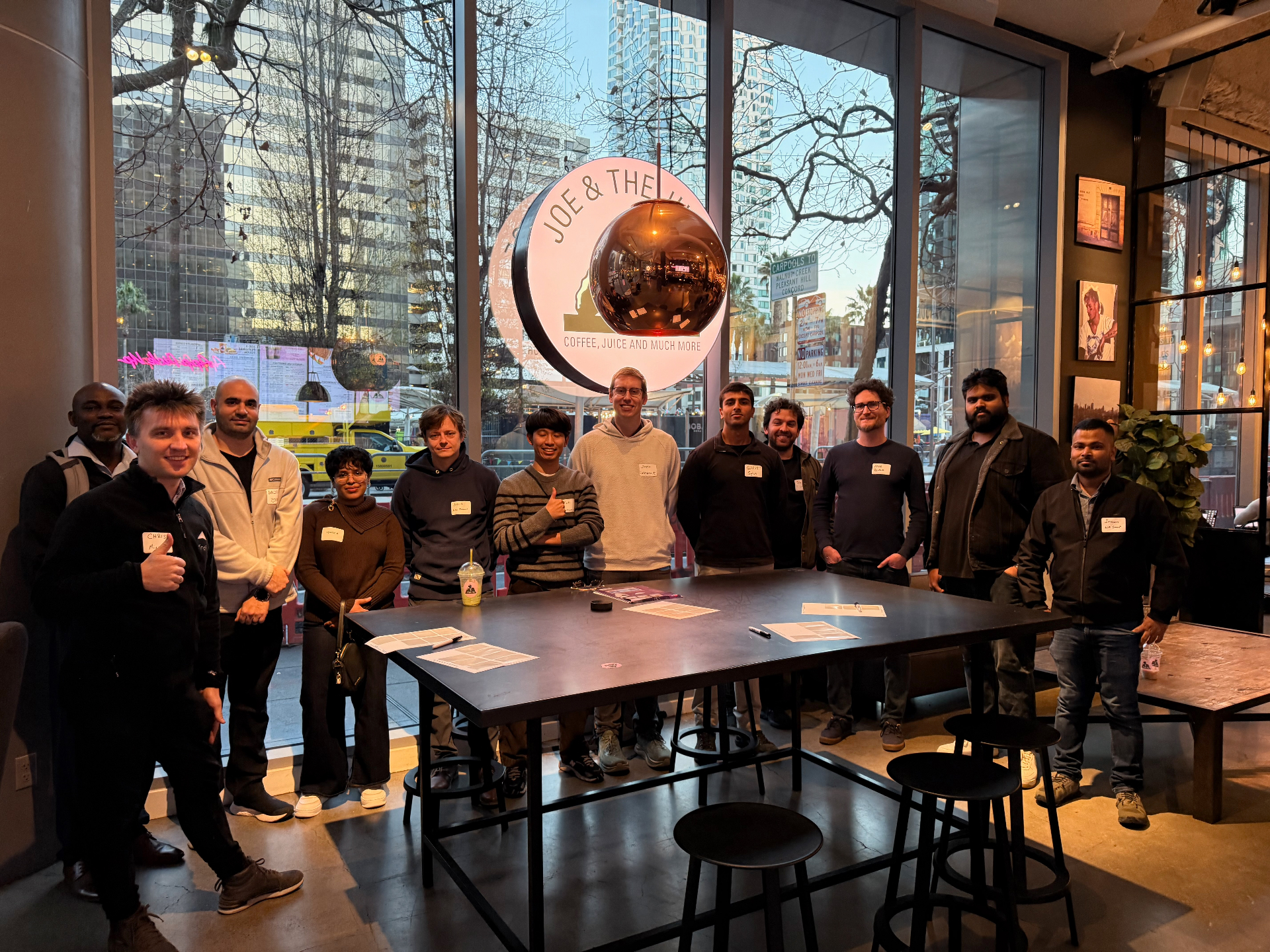 Founders posing around the table at dusk in the SF venue