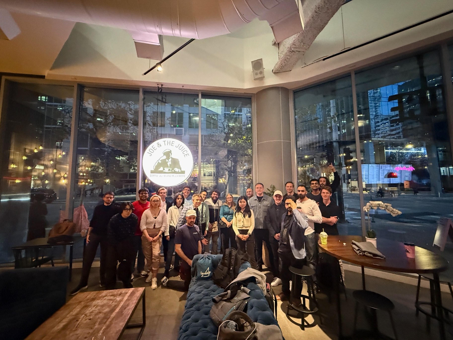 Founders posing together in front of the venue windows