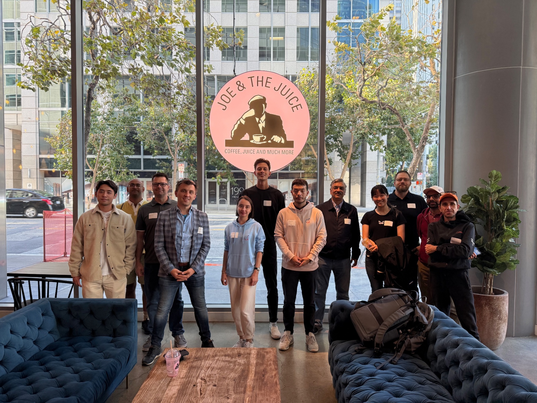 Group of founders in front of the pink Joe & The Juice sign
